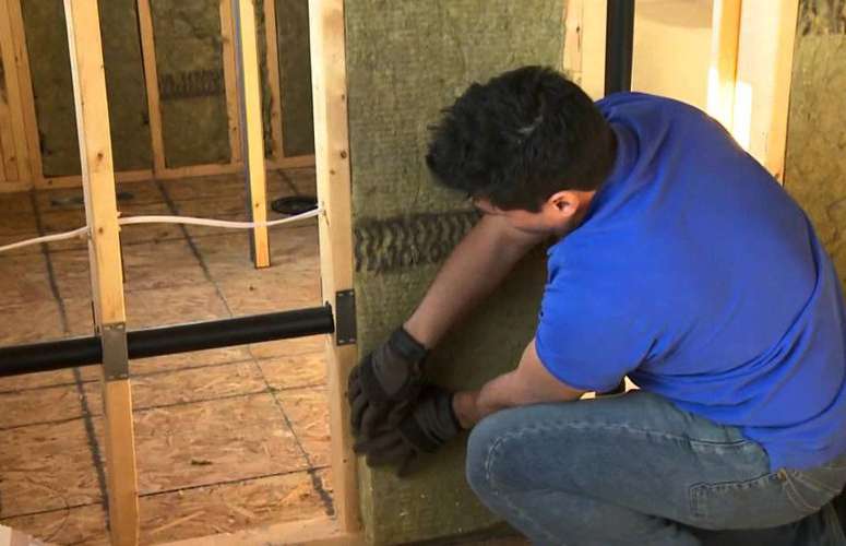 Installing soundproofing batts in interior partition walls of drywall