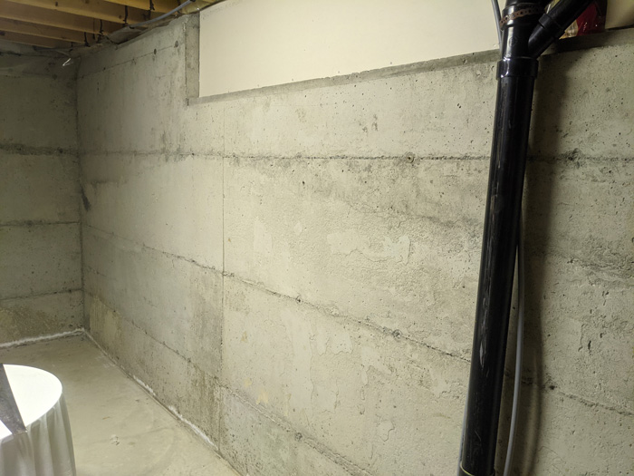 Insulating bare concrete basement walls with rigid foam panels