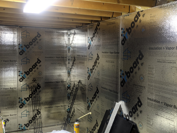 Insulating basement walls with foam bare concrete foil faced